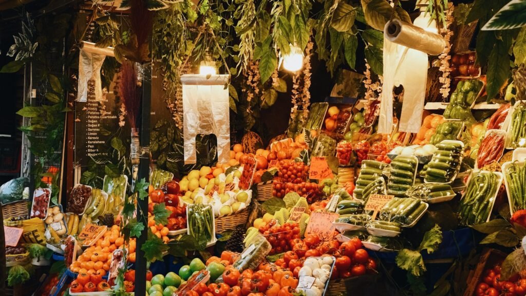 Outdoor market with fresh produce and hanging plants for dairy free MSPI grocery guides
